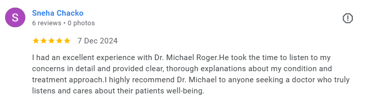 Screenshot of a five-star review by Sneha Chacko for Dr. Michael Roger, praising his attentive listening and thorough explanations. Médecin généraliste Français à Dubaï / GP / French GP / French Doctor / French family medicine