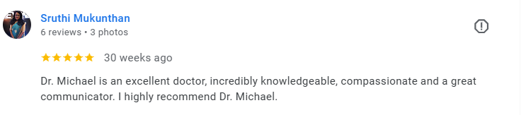 Screenshot of a Google review from Sruthi M., 6 reviews, 3 photos, 30 weeks ago, praising Dr. Michael for being an excellent, knowledgeable, compassionate, and great communicator. Médecin généraliste Français à Dubaï / GP / French GP / French Doctor 