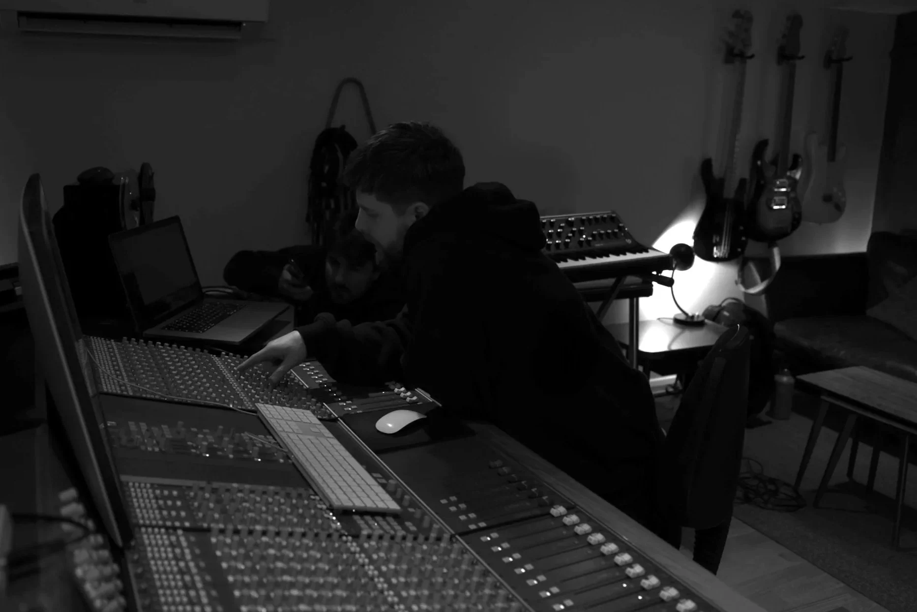 Adam Jaffrey working at an analogue mixing console during a recording session