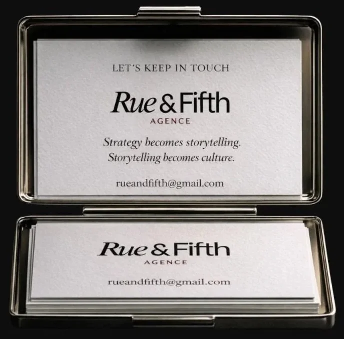 Business cards for Rue & Fifth agency, one inside a metal case and one stacked below, with the tagline 'Strategy becomes storytelling. Storytelling becomes culture.' and email rueandfifth@gmail.com.