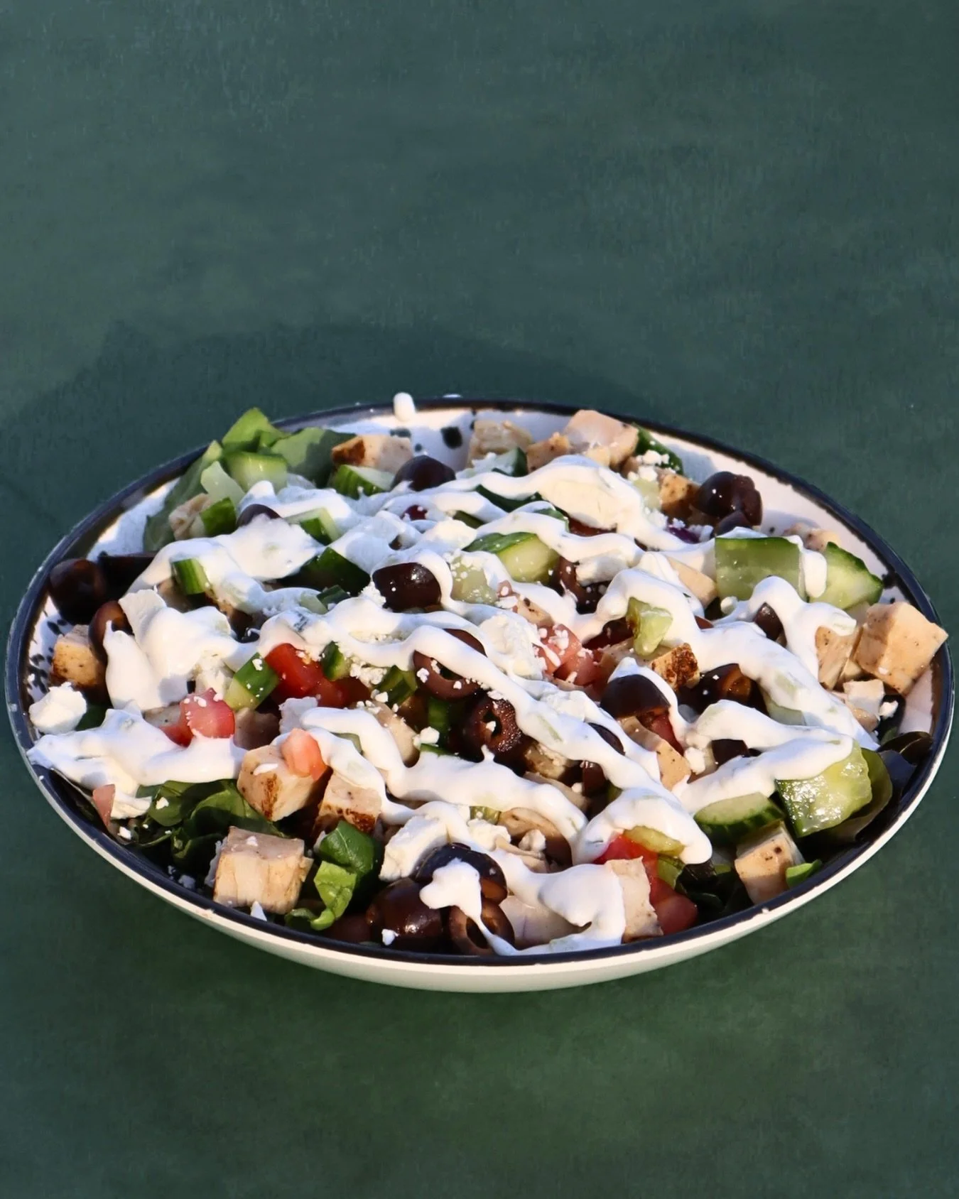 Fresh, crisp, and full of Mediterranean flavor.🥗 
Our Greek Salad comes with cucumber, olives, red onion, diced tomato, black olives, feta cheese, chicken on a bed of lettuce and drizzled with tzatziki sauce ✨

#chickengreek #salad #greeksalad