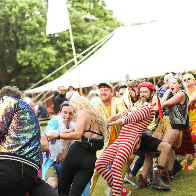 Monsieur Bon Bon participating in a tug of war at The Club House, Wilderness Festival.