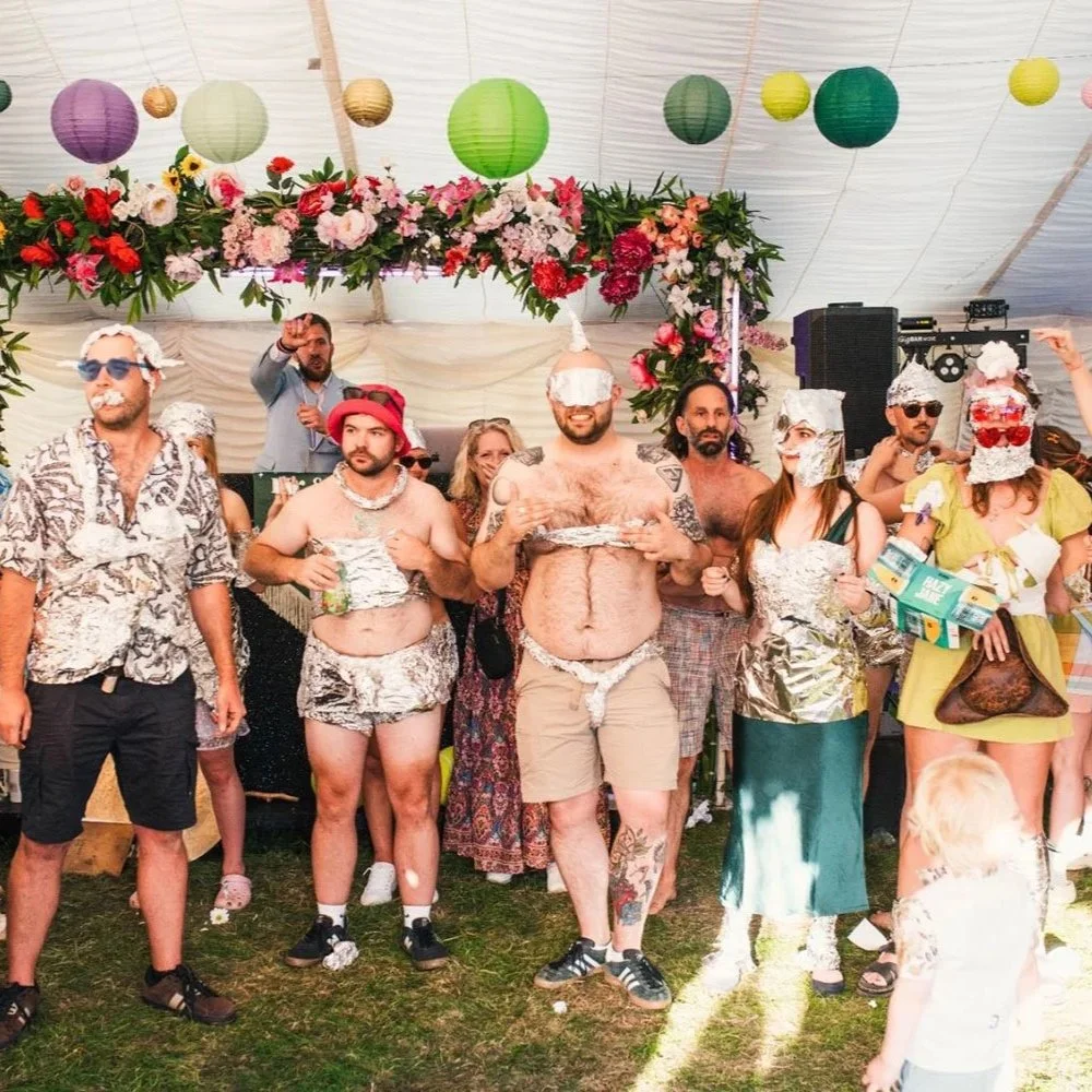 Guests competing in the Foil Robot round of a Wedding Gameshow.