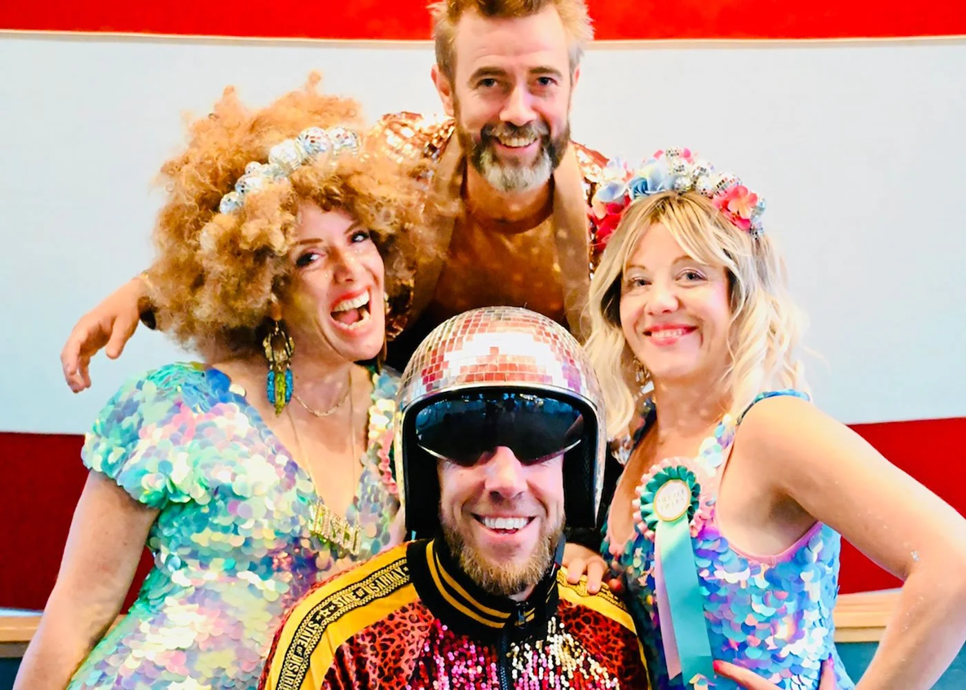 Host Kevin Campbell Davidson and DJ Max Galactic with sequinned dancers at Wilderness Festival 2025.