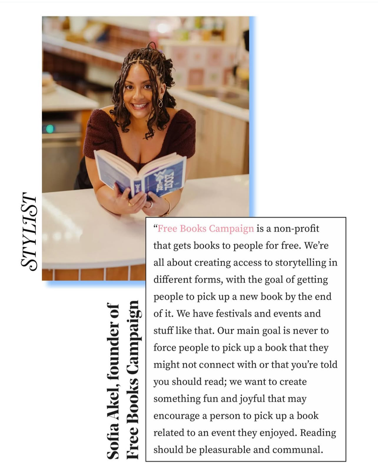 A woman sitting at a counter in a kitchen, holding an open book and smiling at the camera.