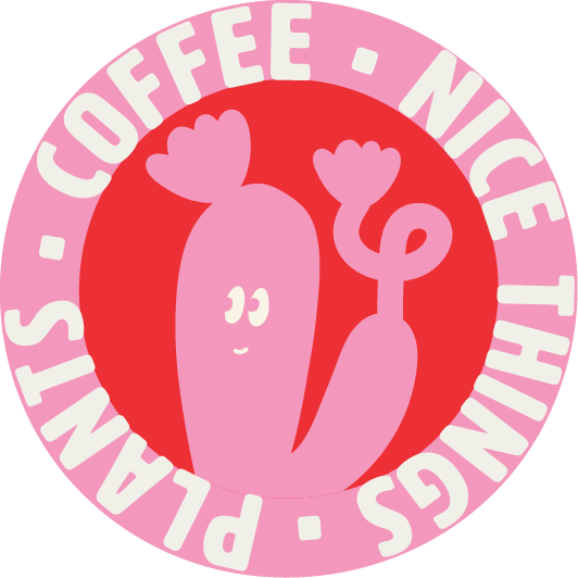 A pink cartoon heart with eyes and a smile, with a pink carrot on its right side. The image has a pink border with white text that says 'PLANT-BASED COFFEE - NICE THINGS' around the circle.
