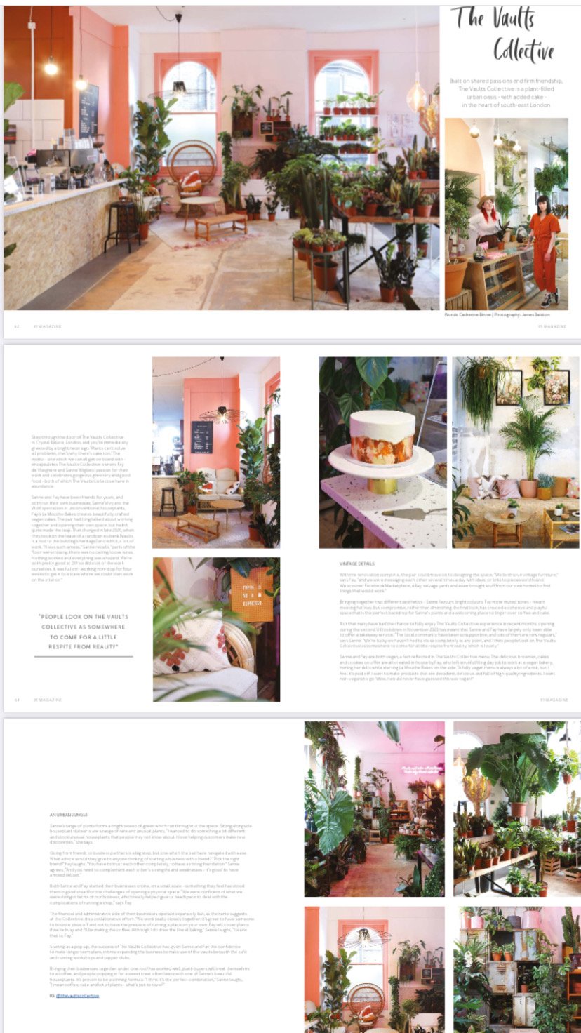 Interior of The Vaults Collective, a plant-filled shop with pink accents, featuring plants, wooden furniture, and seating areas.