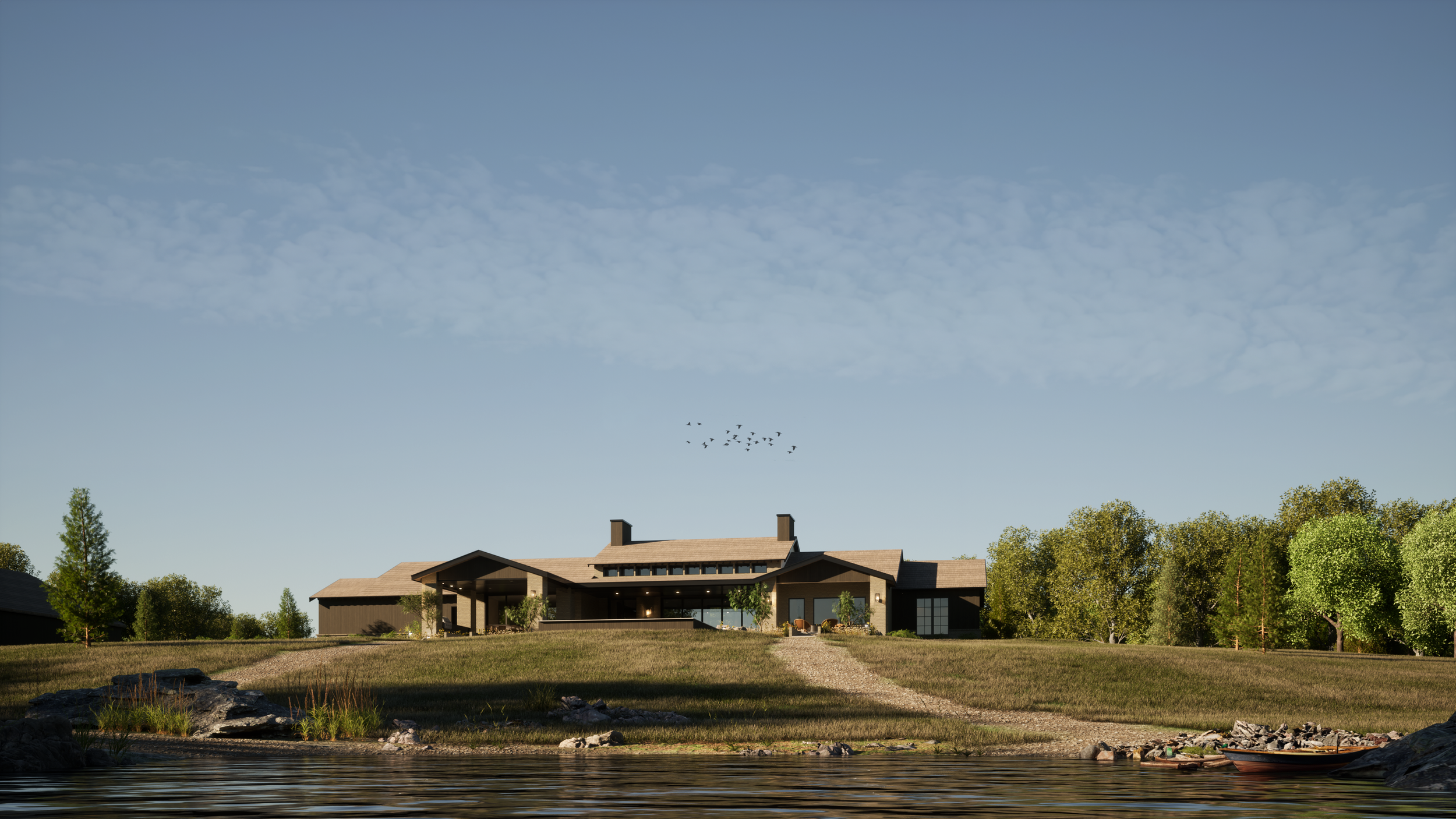 A large modern house with a brown roof and dark exterior walls, situated on a grassy hill by a lake, with trees surrounding it and a flock of birds flying in the sky.