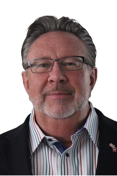 Portrait of a middle-aged man with gray hair and beard wearing glasses, a striped shirt, and a dark blazer.