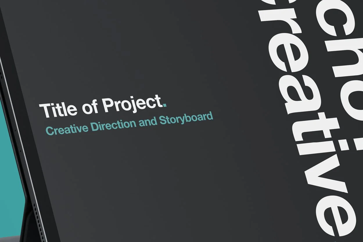Close-up of a digital device screen displaying a project title slide with the text 'Title of Project' and subtitle 'Creative Direction and Storyboard,' with part of a vertical design element reading 'Creative' visible.