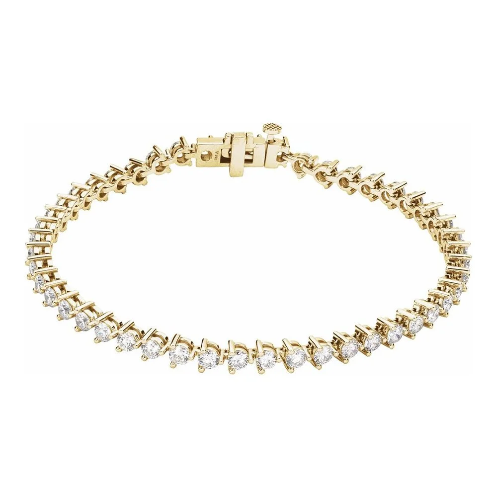 Gold diamond tennis bracelet with a secure clasp on a white background.
