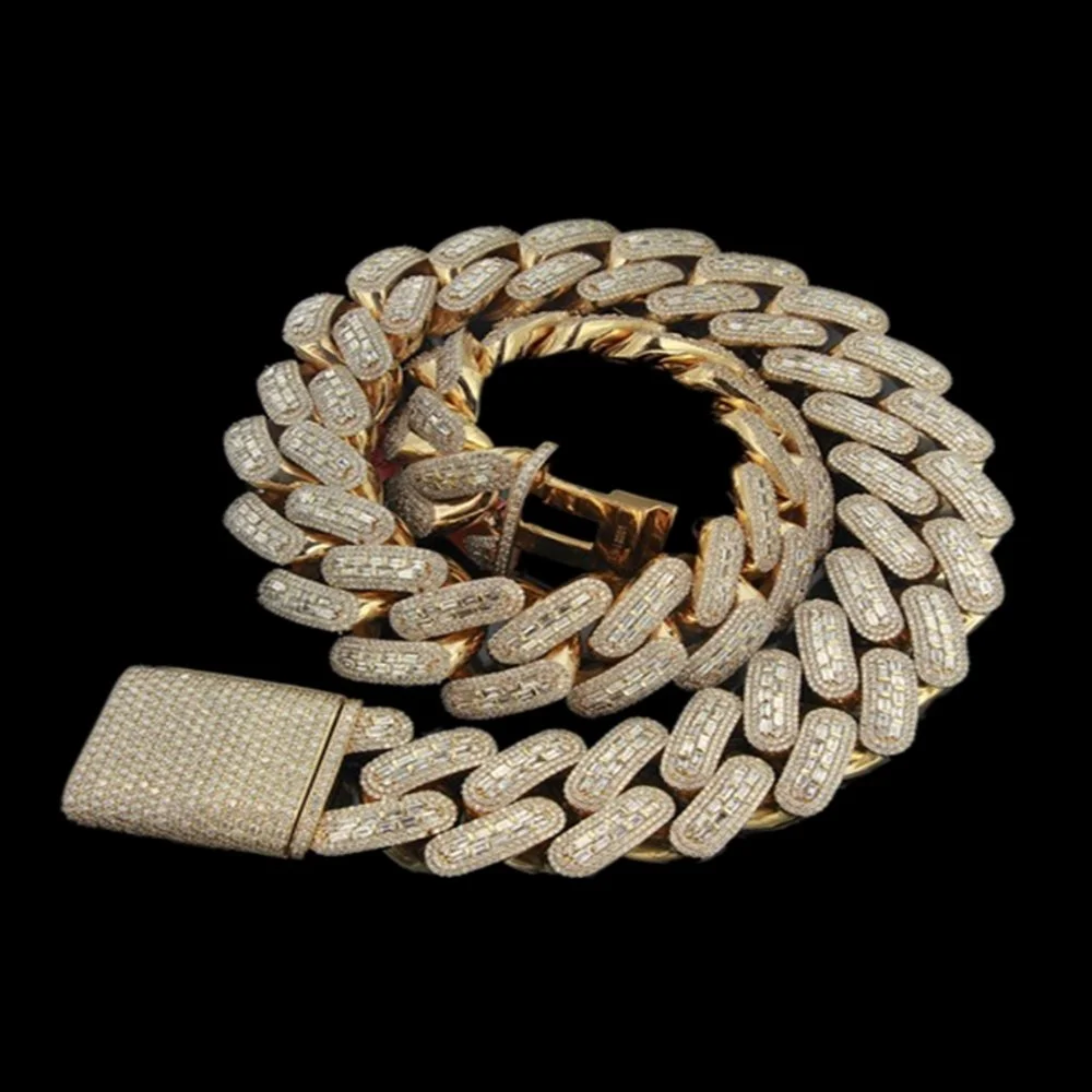 A gold Cuban link chain necklace with a diamond-encrusted clasp displayed against a black background.