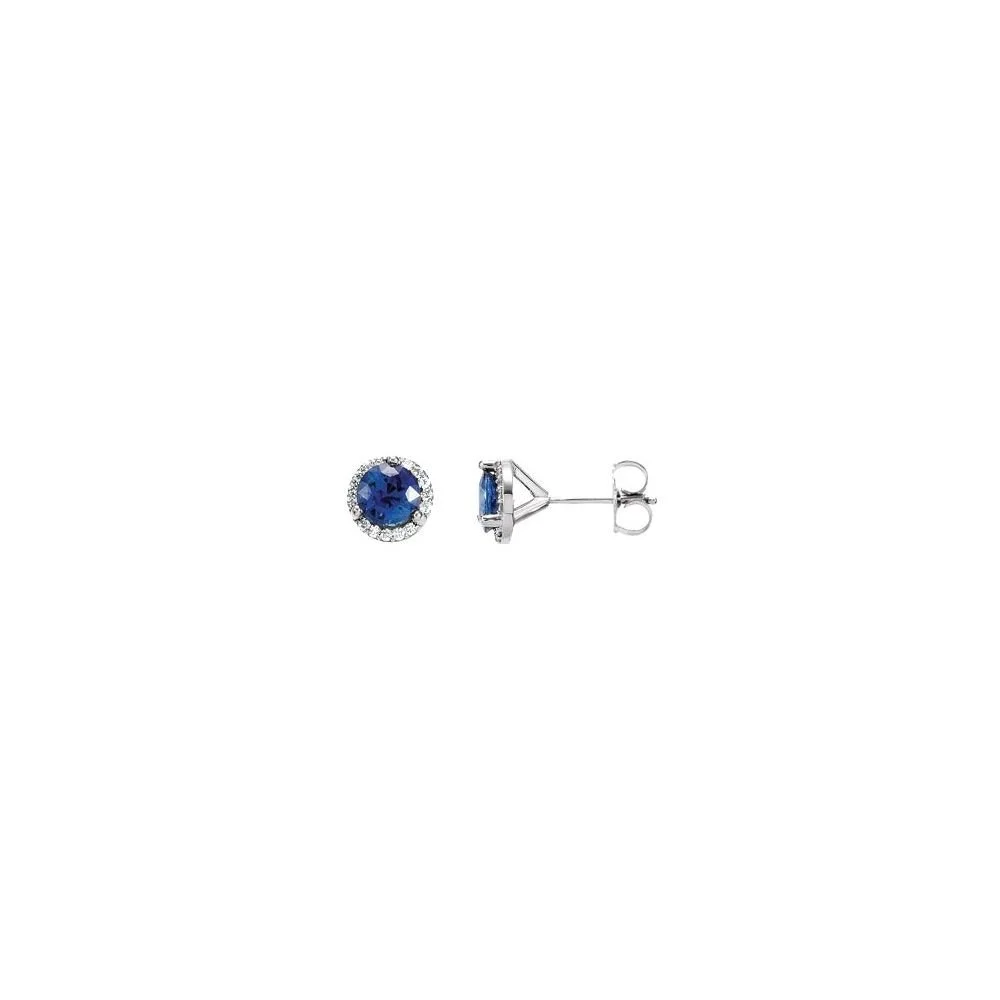 A pair of blue gemstone stud earrings with silver settings, one showing the front view with a dark blue center stone surrounded by small clear stones, and the other showing the side view of the earring post and setting.