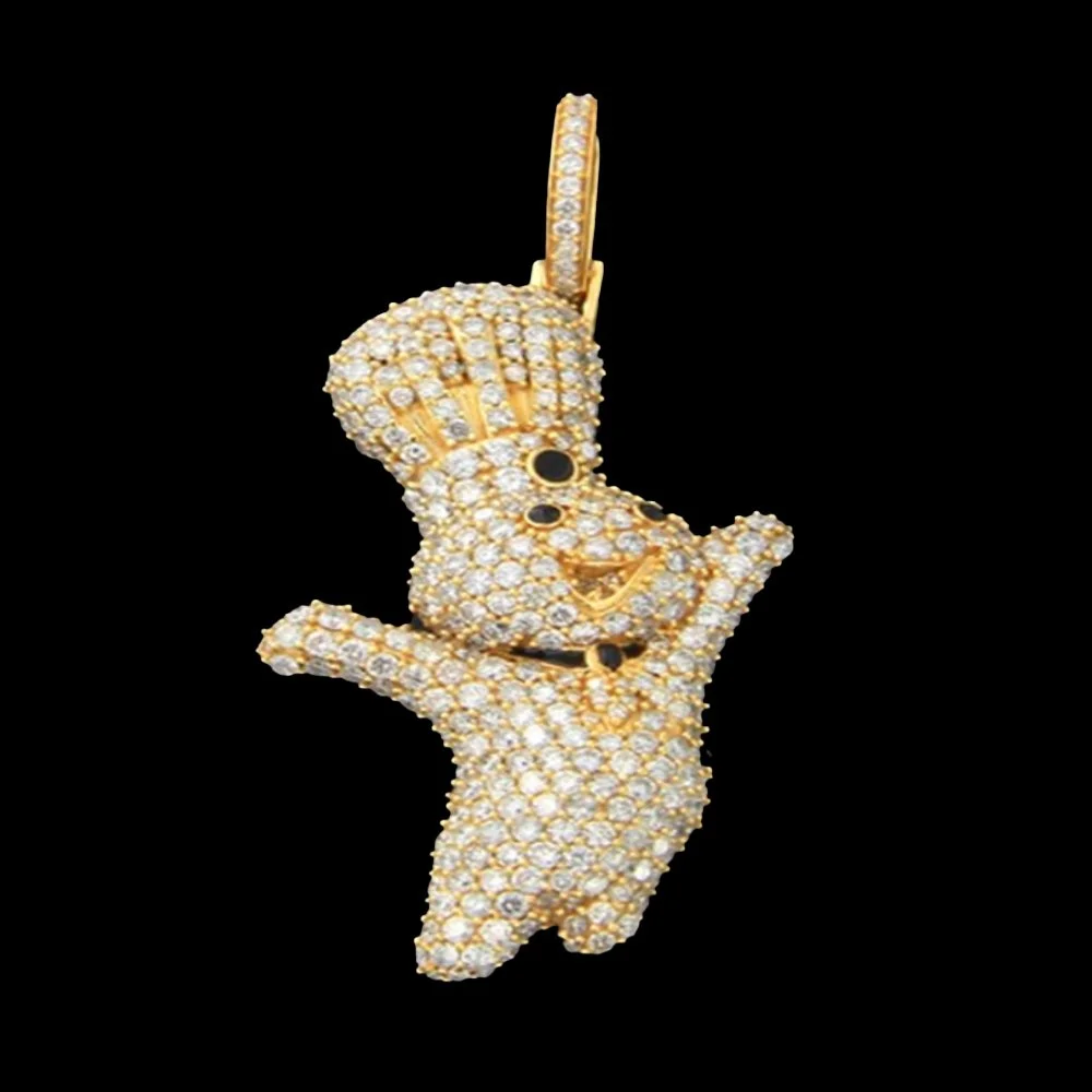 Gold and diamond pendant shaped like a cartoon character with a large head, big eyes, and a hat, on a black background.