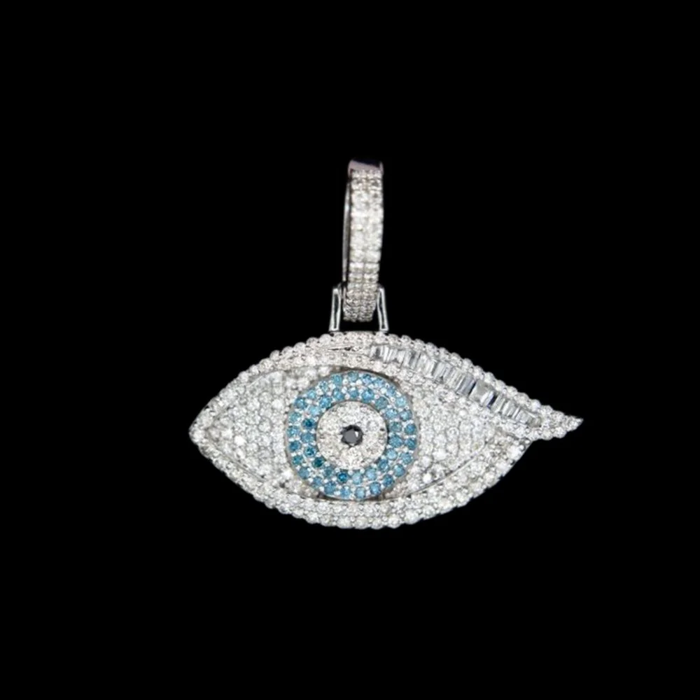 Jewelry pendant shaped like an eye with intricate diamond and blue gemstone details, set against a black background.