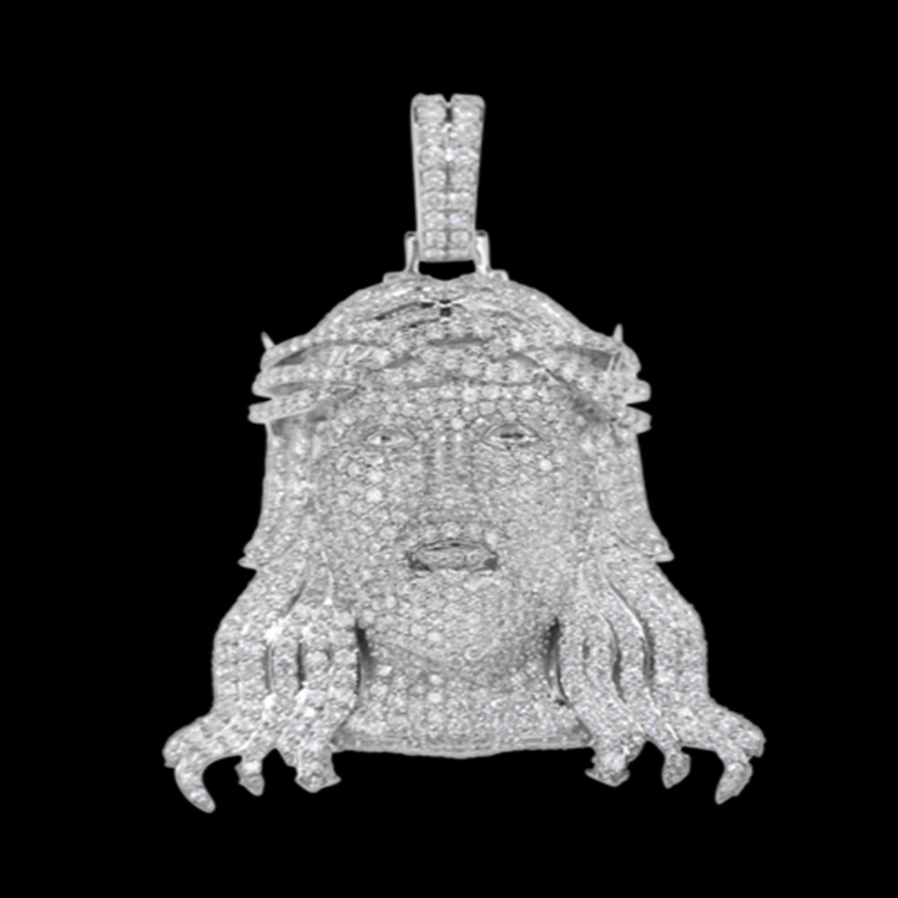 A pendant featuring a diamond-encrusted design of a face with multiple snake-like creatures around it, against a black background.