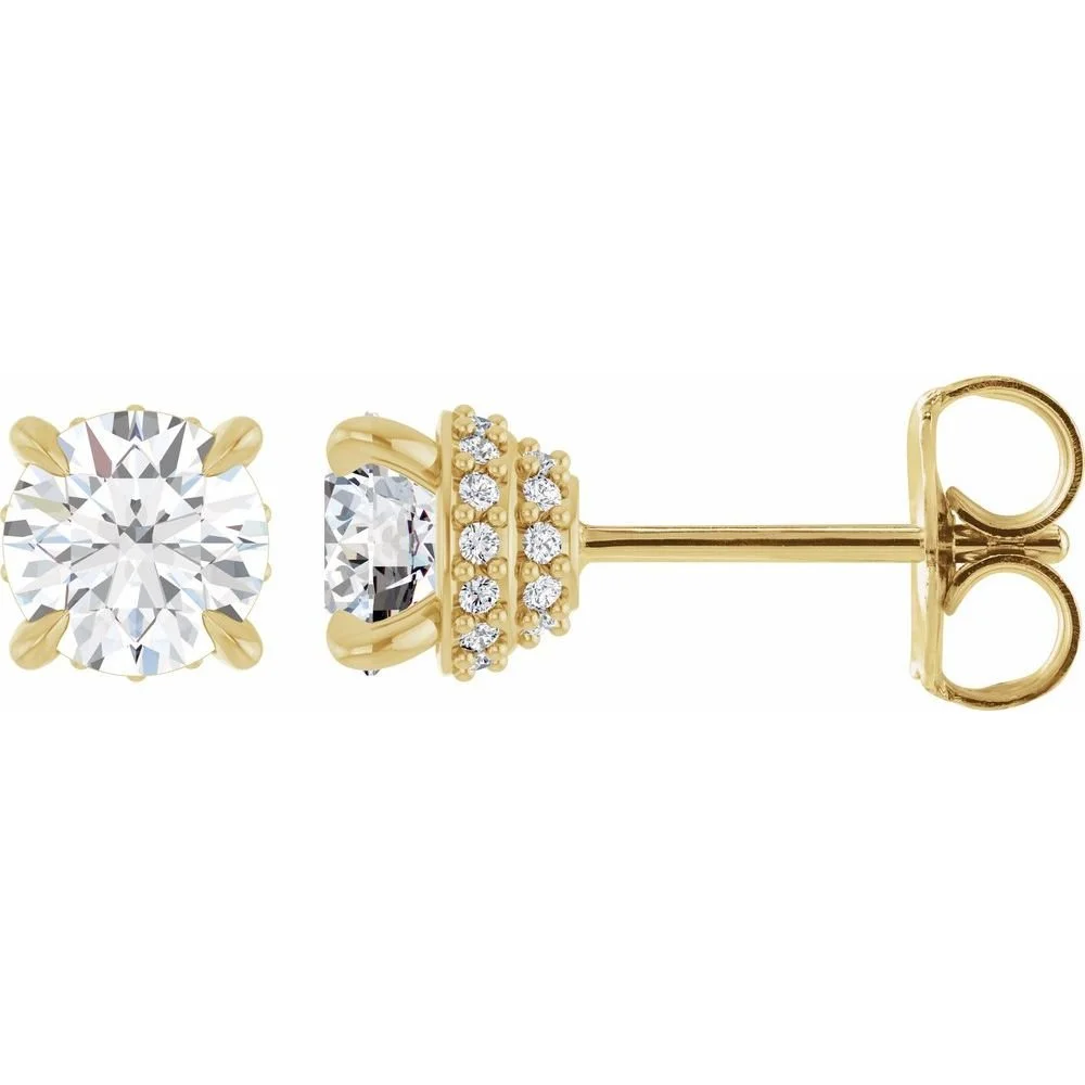 Close-up of a pair of gold stud earrings with large round-cut diamonds and smaller diamonds in a decorative setting.