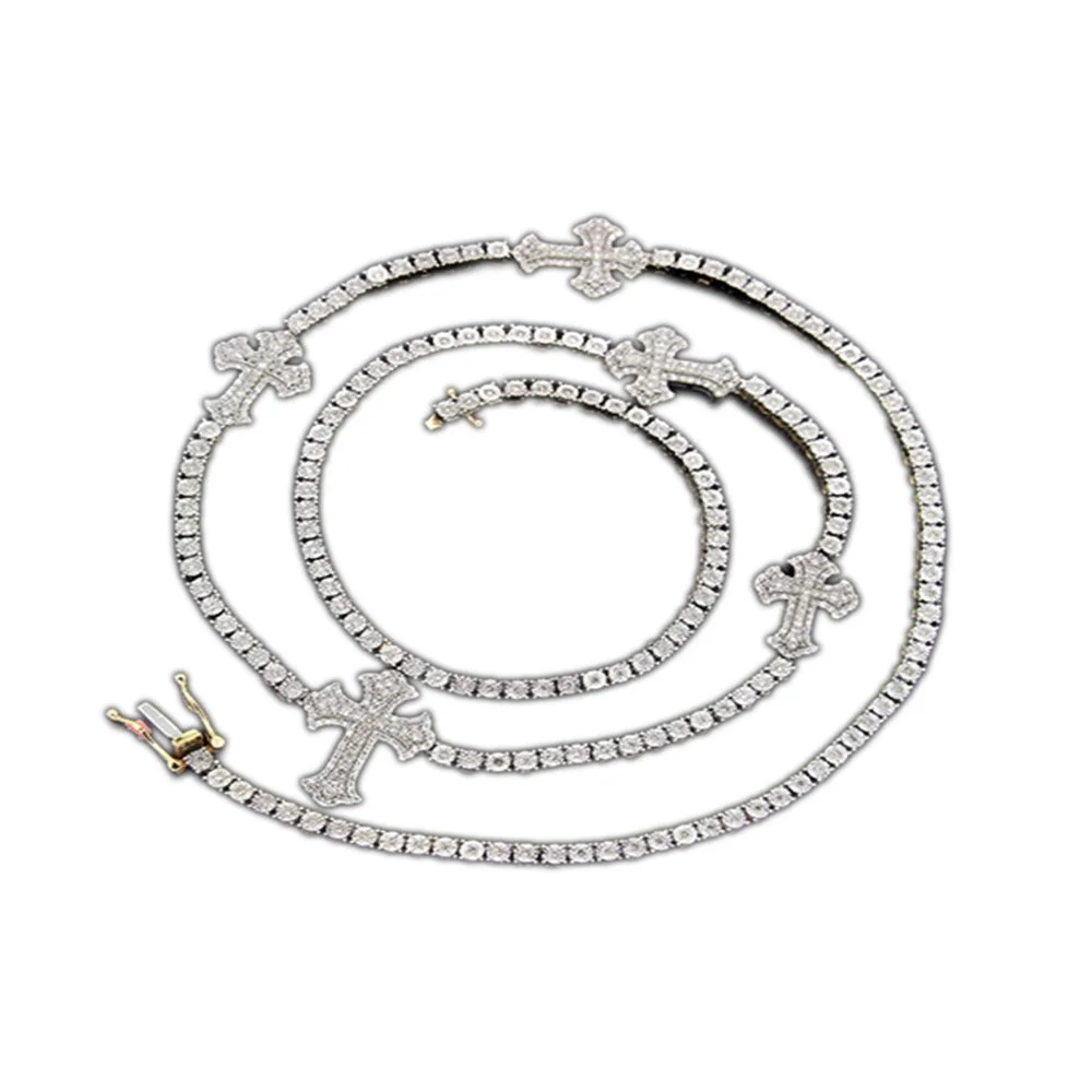 Silver jewelry set with cross-shaped pendants, including a necklace, bracelet, and ring, all adorned with small gemstones.