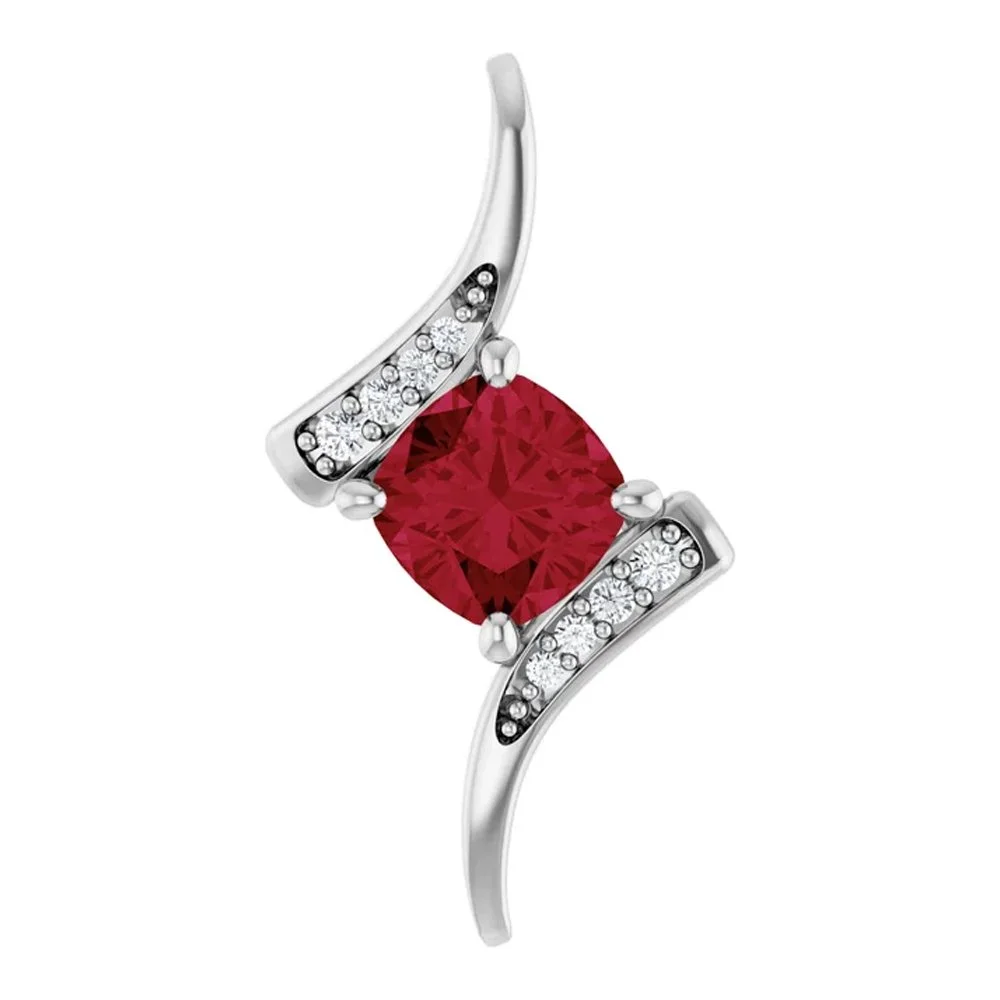 Silver ring featuring a prominent red oval gemstone with small clear diamonds on its curved double band.