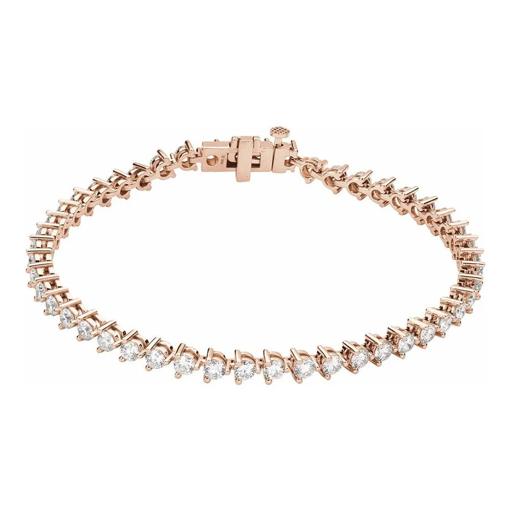 A rose gold tennis bracelet with clear gemstones and a clasp.