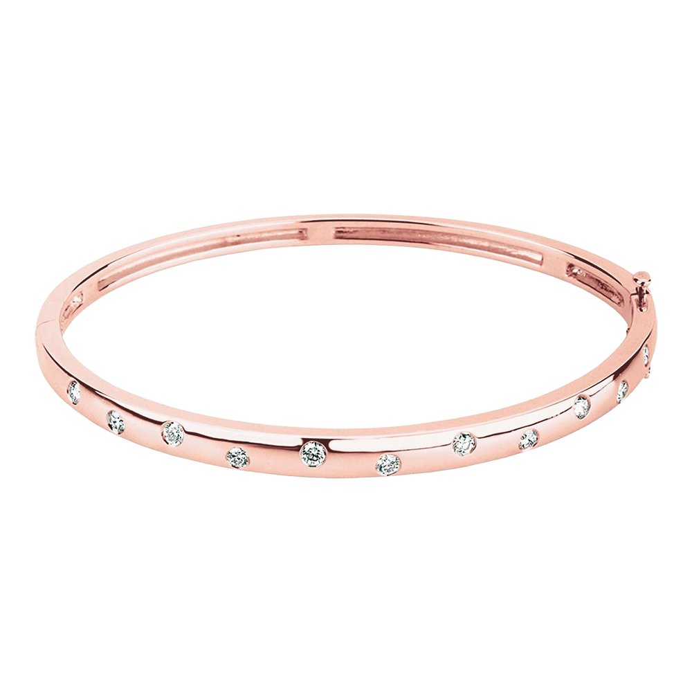 A rose gold bangle bracelet with small clear embedded stones arranged around it.