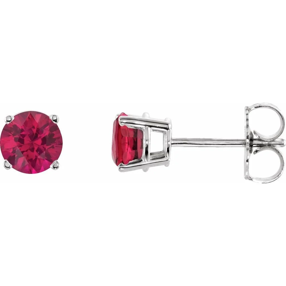 A pair of silver stud earrings with round cut pink gemstones.