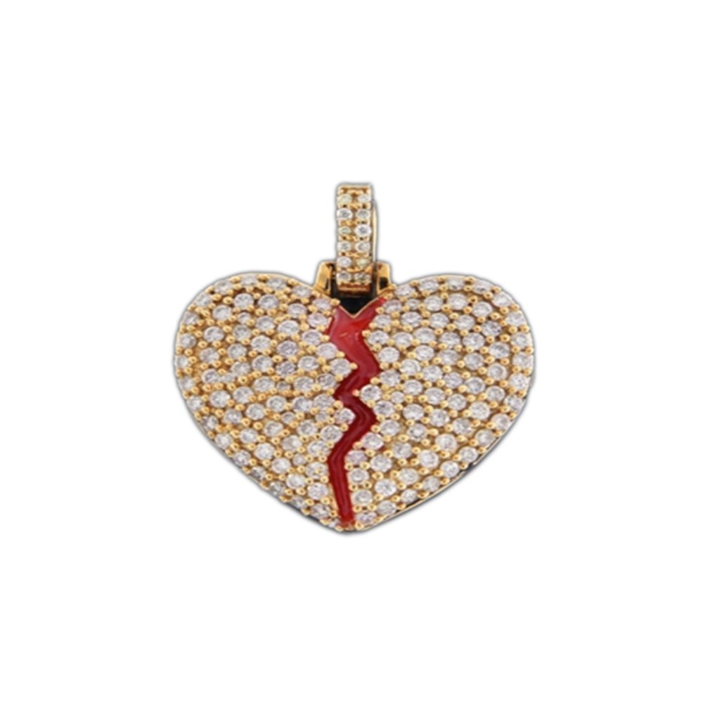 Gold and diamond pendant in the shape of a broken heart with red enamel crack detail.