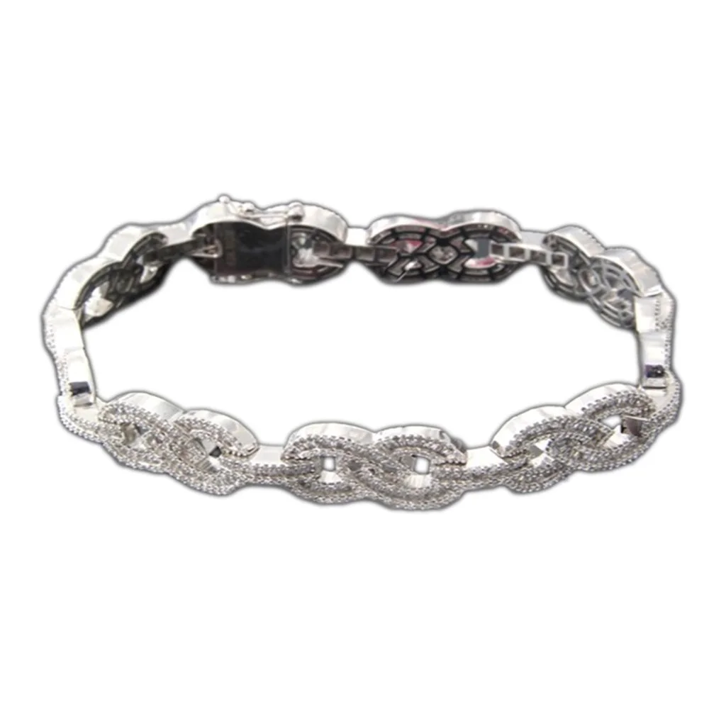 Silver bracelet with linked circular patterns, some parts are decorated with small sparkling stones.