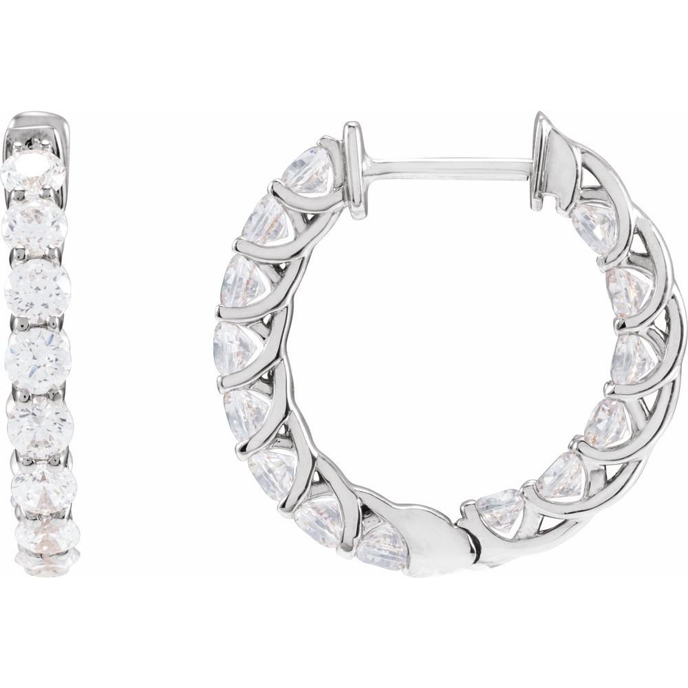 Silver earrings with clear gemstones, one in a row of four stones and the other as a hoop with multiple stones and leaf-shaped details.