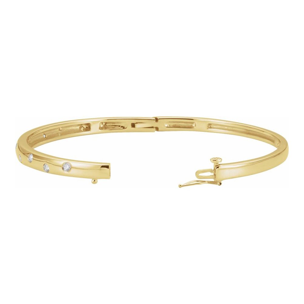Gold bracelet with small embedded diamonds and a clasp closure.