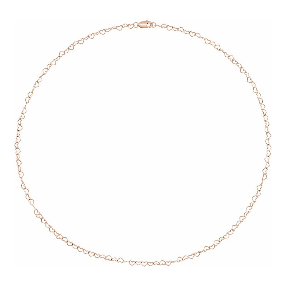 A delicate gold chain necklace with interlocking heart-shaped links, laid out flat on a white background.