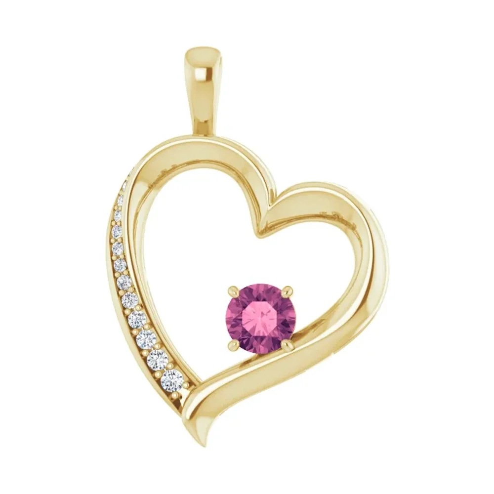 Gold heart-shaped pendant with small diamonds along one side and a pink gemstone in the center.