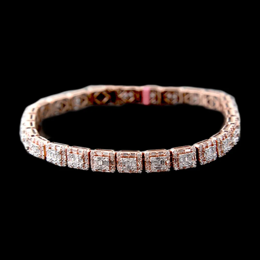 A diamond tennis bracelet with a pink gemstone clasp, displayed against a black background.