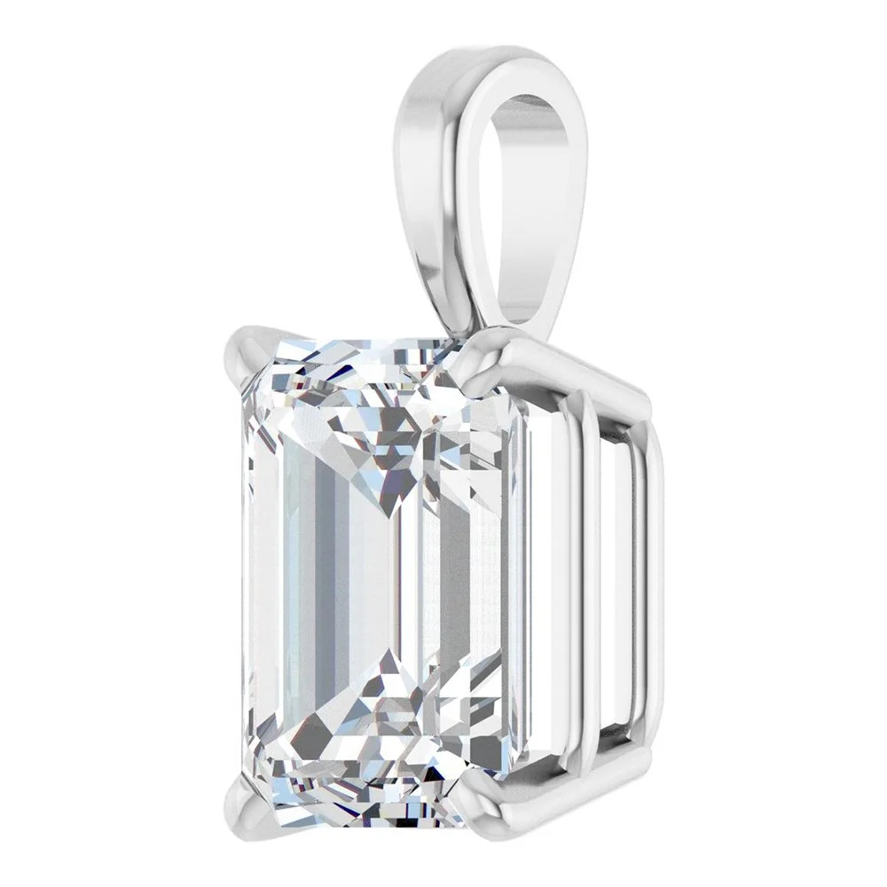 A pendant with a large emerald-cut diamond set in a sleek silver frame and bail.