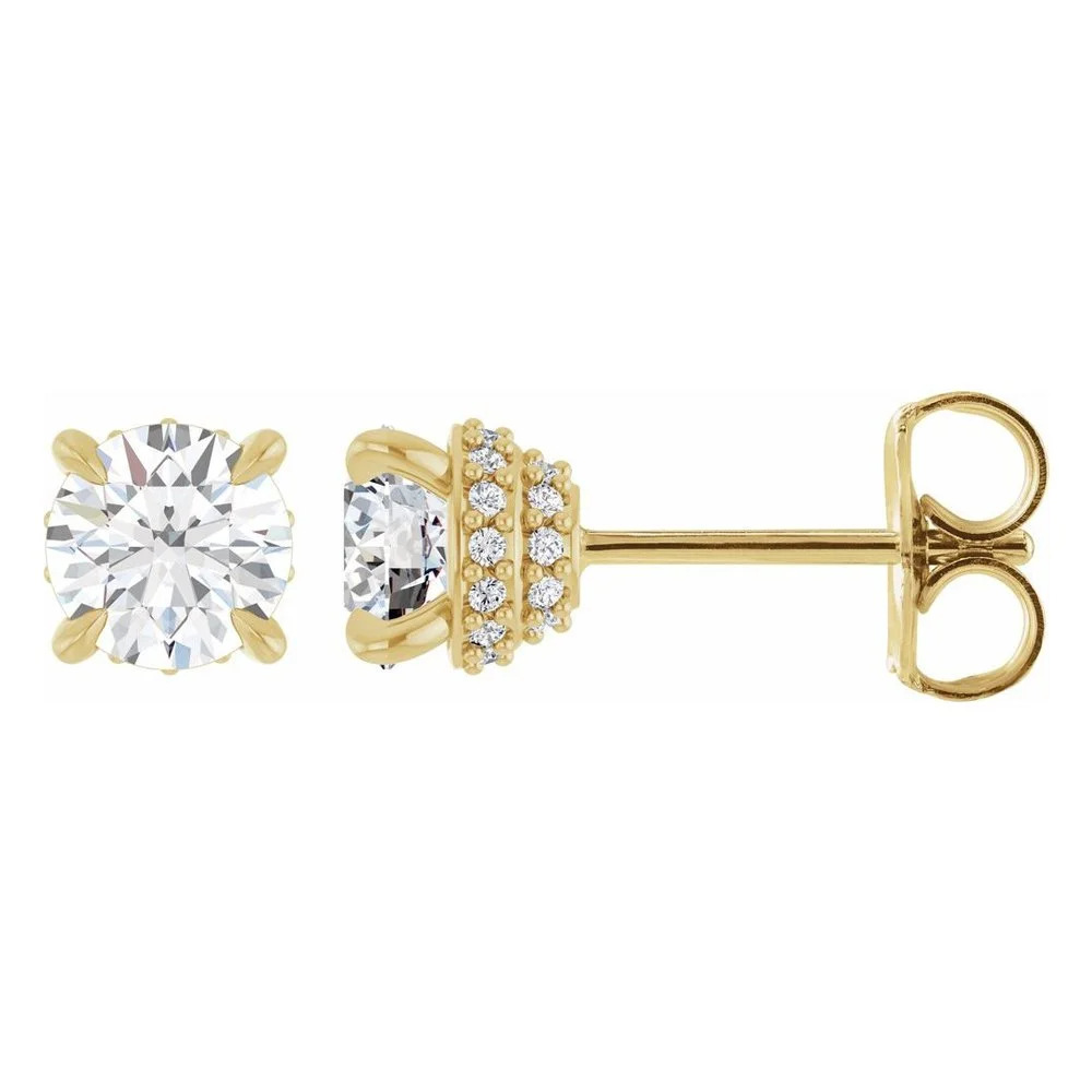 A pair of gold stud earrings with large round diamonds and smaller diamonds in a cluster setting.