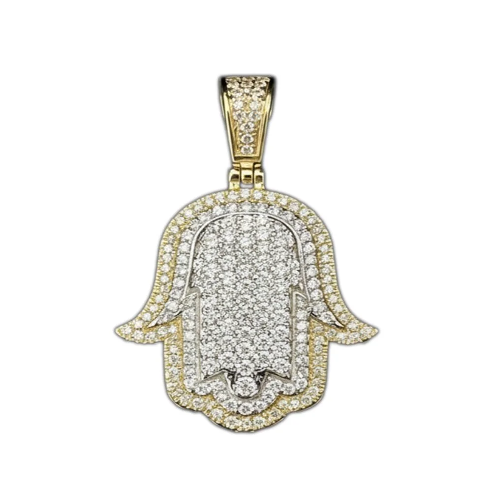 Gold and silver Hamsa pendant encrusted with diamonds.