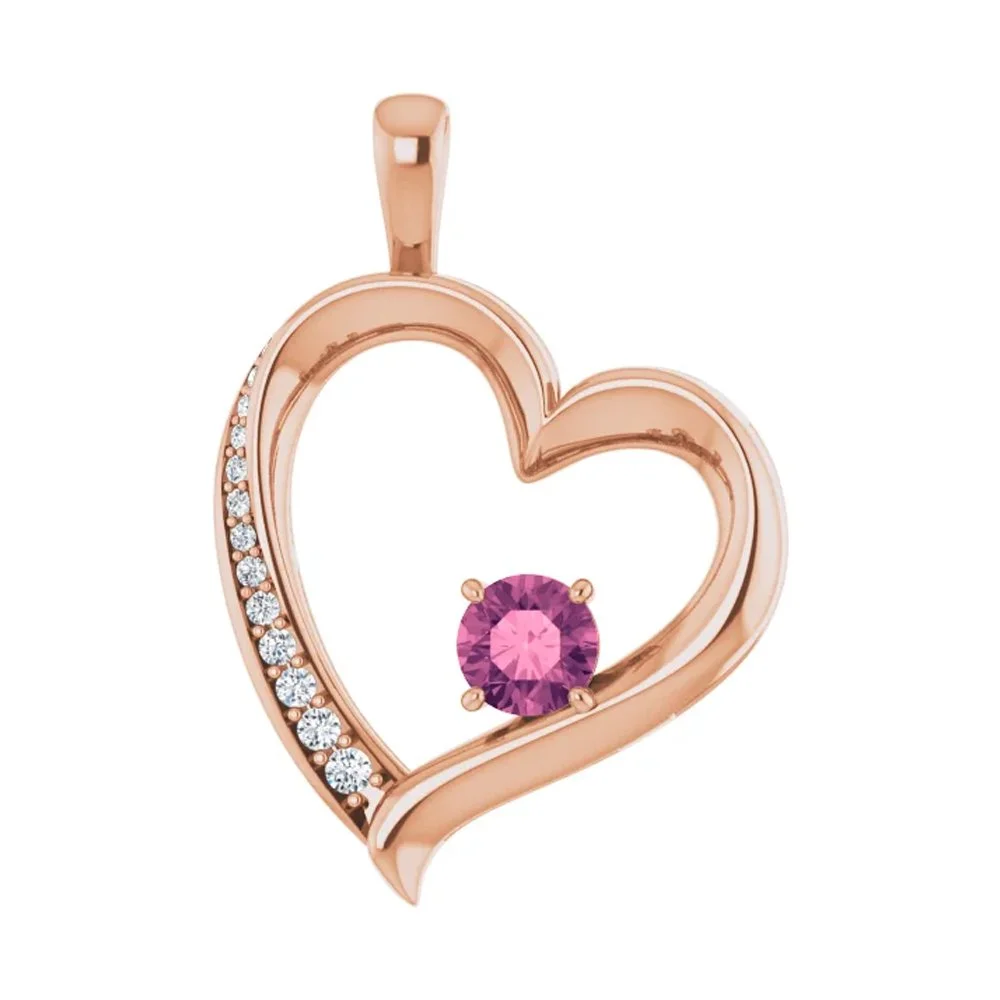 Rose gold heart-shaped pendant with white diamonds along one side and a pink gemstone in the center.