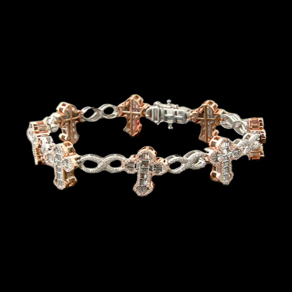A gold and silver bracelet with a chain link design and multiple cross-shaped charms, set with diamonds, arranged in a circle on a black background.