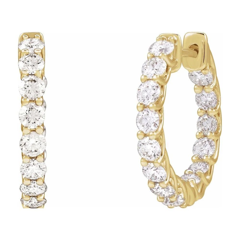 Gold hoop earrings with clear round-cut diamonds set in a row.