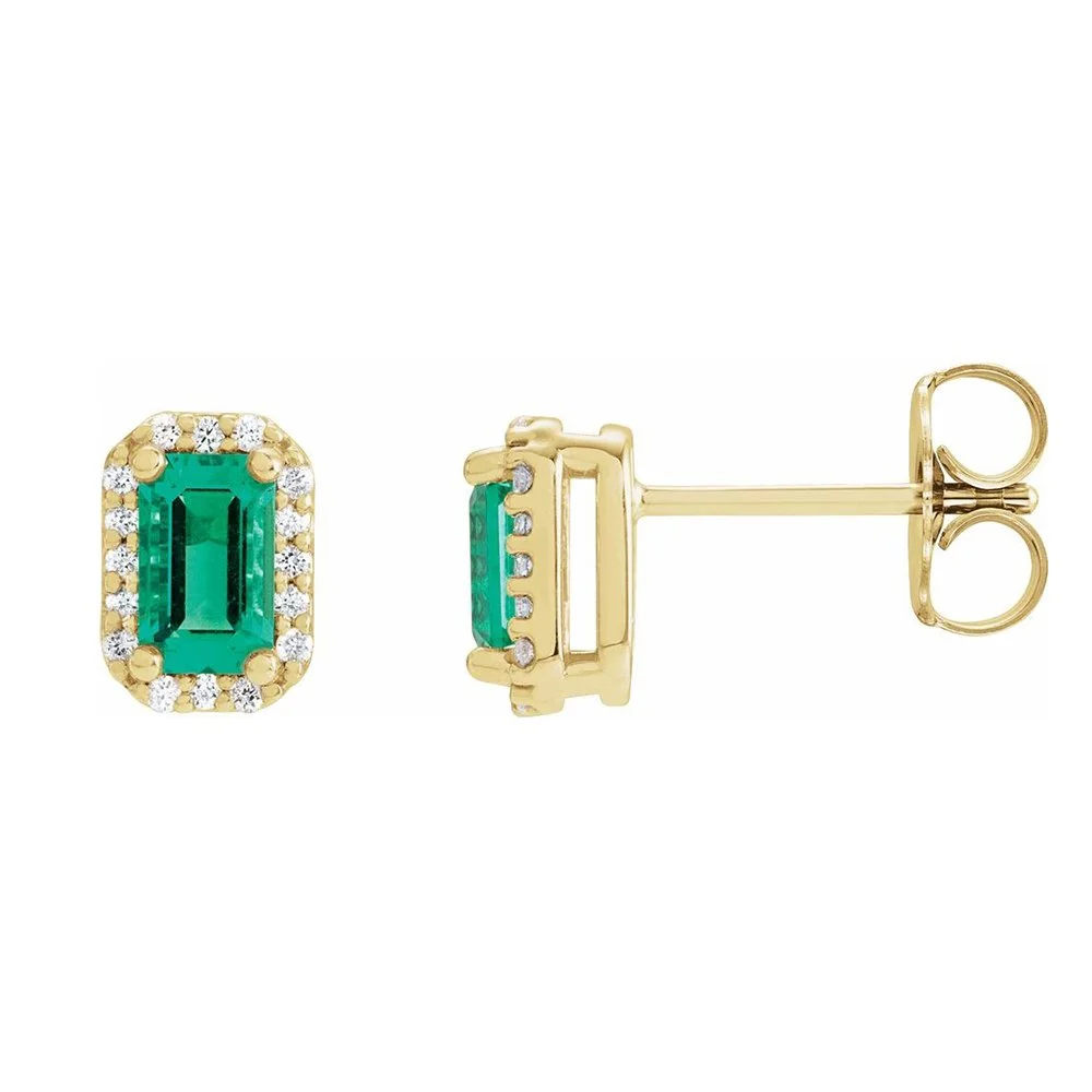 Gold earrings with emerald center stones surrounded by small diamonds.