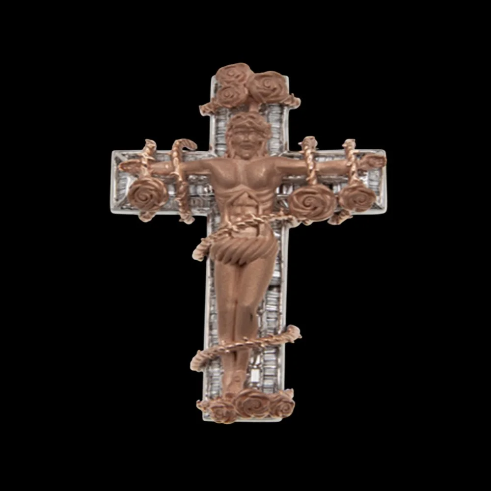 A decorative crucifix featuring a detailed figure of Jesus Christ with a silver cross background and ornate scrollwork on the arms and base, set against a black background.