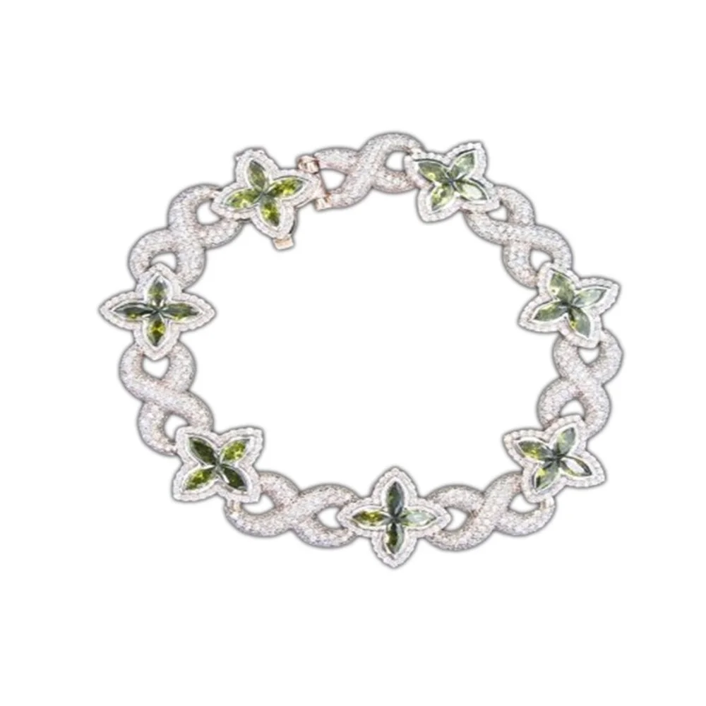 A silver necklace with butterfly-shaped designs featuring green and black stones, interconnected by circular links, set against a white background.