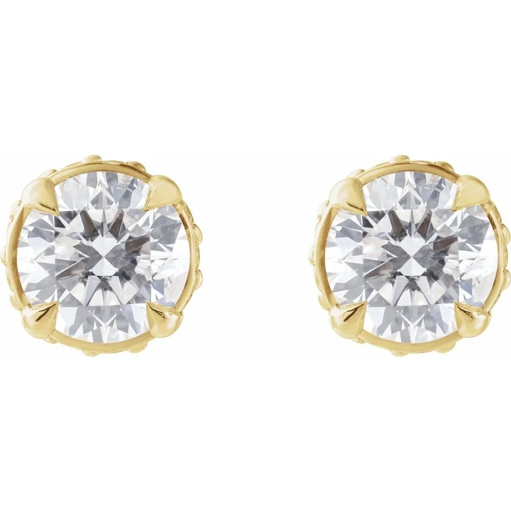 Pair of gold stud earrings with round-cut diamonds.