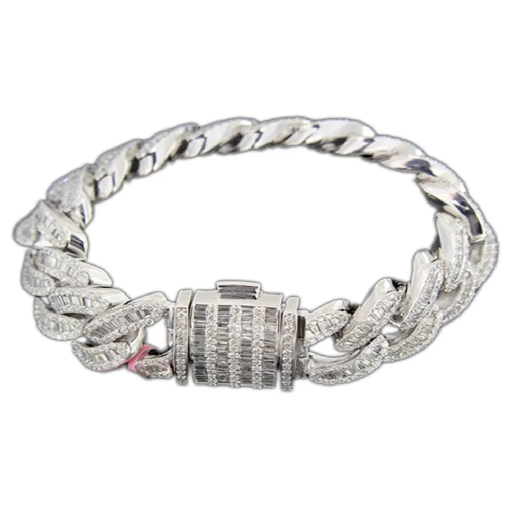 A silver bracelet with a thick chain design, encrusted with numerous small diamonds, featuring a large clasp also decorated with diamonds.