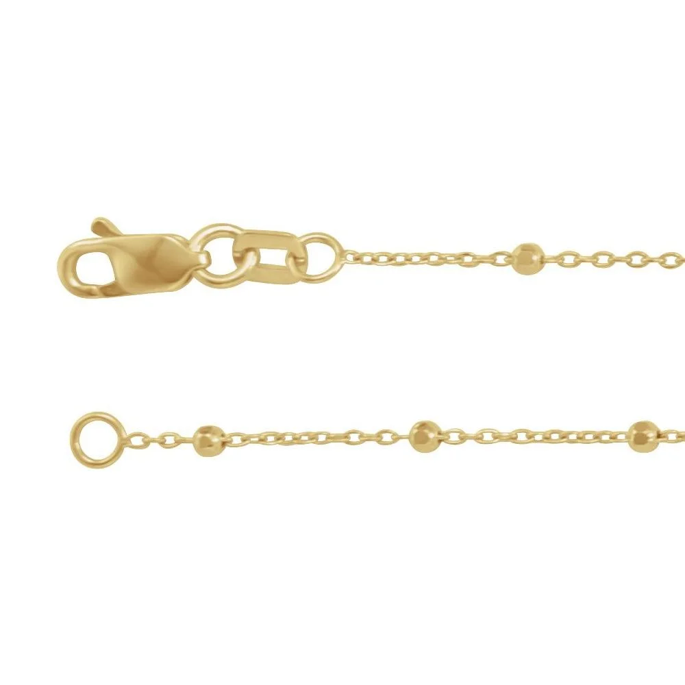 Close-up of a gold chain necklace with a lobster clasp and circular links with small spherical beads.