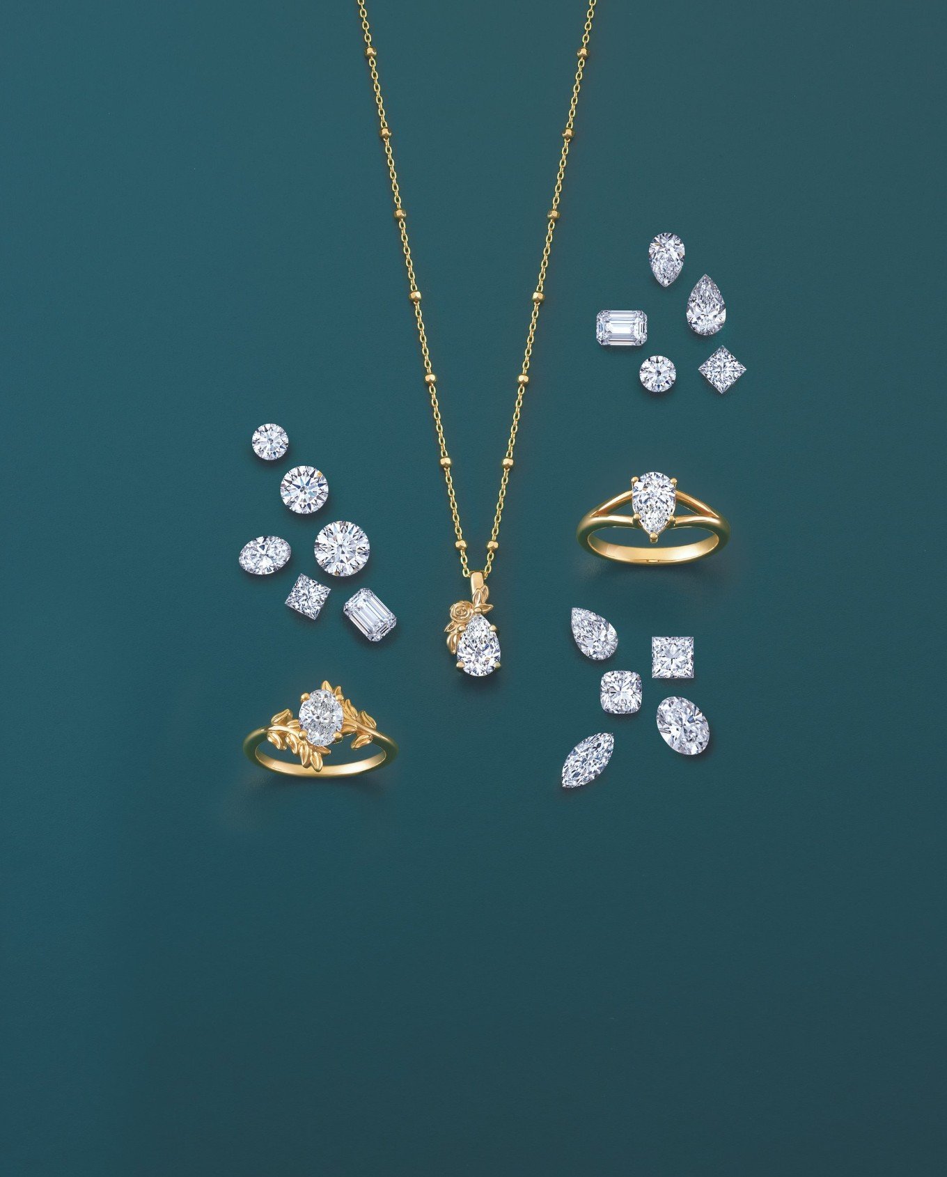 Gold jewelry set includes a necklace with a diamond pendant, two diamond rings, and an array of diamonds surrounding them on a teal background.