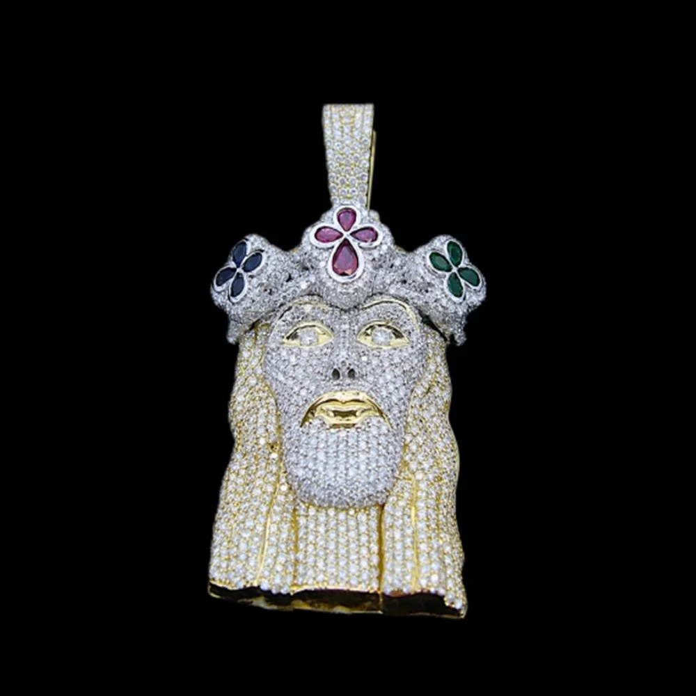 A jeweled pendant resembling the face of a bearded man wearing a crown with colorful flowers, covered entirely in diamonds and precious stones.