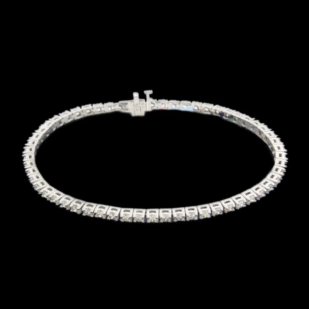 A silver bracelet with small square links, each decorated with engraved patterns, resting on a black background.