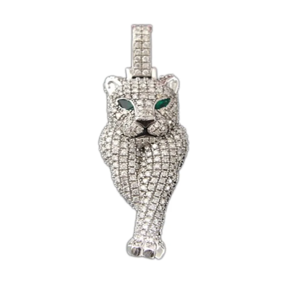 A silver pendant in the shape of a tiger with green eyes, encrusted with clear rhinestones.