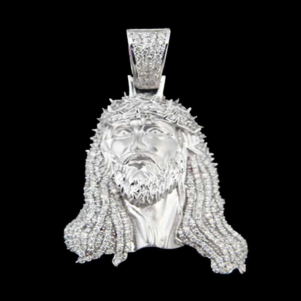 A silver pendant featuring a detailed portrait of Jesus Christ with a crown of thorns, long hair, a beard, and a sad expression, set against a black background.